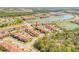 Bird's-eye view showcases a community with lakes and numerous townhomes and buildings at 3621 Casello Dr, New Smyrna Beach, FL 32168