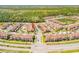 Beautiful aerial view of a residential community with lush greenery and a pond at 3621 Casello Dr, New Smyrna Beach, FL 32168
