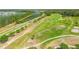 Aerial view of a lush golf course, ponds, and meticulously kept grounds within the Venetian Bay community at 3621 Casello Dr, New Smyrna Beach, FL 32168