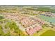High aerial shot capturing a community with ponds, trees, and multiple residential buildings at 3621 Casello Dr, New Smyrna Beach, FL 32168