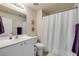 Clean bathroom featuring a large mirror, vanity, and a shower with a white curtain at 3621 Casello Dr, New Smyrna Beach, FL 32168