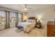 Bright bedroom featuring a ceiling fan, neutral walls, large windows, and comfortable furnishings at 3621 Casello Dr, New Smyrna Beach, FL 32168
