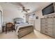 Cozy bedroom with a ceiling fan, a desk, a TV, and neutral decor at 3621 Casello Dr, New Smyrna Beach, FL 32168