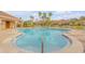 Sparkling community pool with ample seating, palm trees, and views of nearby buildings at 3621 Casello Dr, New Smyrna Beach, FL 32168