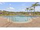Relaxing community pool area with palm trees and comfortable lounge chairs for residents at 3621 Casello Dr, New Smyrna Beach, FL 32168