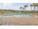 Inviting community pool with lounge chairs, palm trees, and a view of surrounding homes at 3621 Casello Dr, New Smyrna Beach, FL 32168