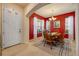 Inviting dining room with a wooden table, four chairs, and bright red walls at 3621 Casello Dr, New Smyrna Beach, FL 32168