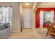 Inviting entryway with neutral tones, a white front door, and a decorative mirror, offering a warm welcome at 3621 Casello Dr, New Smyrna Beach, FL 32168