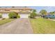 Charming townhome with a brick driveway, well-manicured landscaping, and an attached two-car garage at 3621 Casello Dr, New Smyrna Beach, FL 32168