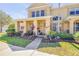 Inviting two-story townhome with a well-manicured lawn and colorful landscaping at 3621 Casello Dr, New Smyrna Beach, FL 32168