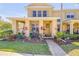 Welcoming townhome featuring a charming porch and vibrant landscaping at 3621 Casello Dr, New Smyrna Beach, FL 32168