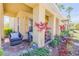 Charming front porch with comfortable wicker furniture and lush landscaping at 3621 Casello Dr, New Smyrna Beach, FL 32168