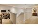 Second-floor hallway with beige carpet, ceiling fan, and railing at 3621 Casello Dr, New Smyrna Beach, FL 32168