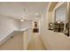 Neutral hallway with ceiling fan, carpet, and wall decor at 3621 Casello Dr, New Smyrna Beach, FL 32168