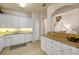 Traditional-style kitchen featuring white cabinets, recessed lighting, and tile flooring at 3621 Casello Dr, New Smyrna Beach, FL 32168