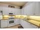 Well-maintained kitchen featuring white cabinets and appliances, providing a clean and functional space at 3621 Casello Dr, New Smyrna Beach, FL 32168