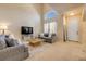 Bright living room with high ceilings, a large window, and comfortable sofas, perfect for relaxation at 3621 Casello Dr, New Smyrna Beach, FL 32168