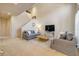 Spacious living room with a cozy seating arrangement and staircase, bathed in natural light at 3621 Casello Dr, New Smyrna Beach, FL 32168