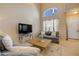 Bright living room with vaulted ceiling, showcasing comfortable seating and natural light at 3621 Casello Dr, New Smyrna Beach, FL 32168