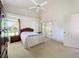 Vaulted ceiling bedroom with carpet, ceiling fan, and ample natural light at 3635 Kingswood Ct, Clermont, FL 34711