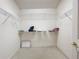 Walk-in closet with carpet, ample shelving, and neutral paint at 3635 Kingswood Ct, Clermont, FL 34711