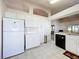 Bright kitchen featuring white appliances and cabinets, and tile floors at 3635 Kingswood Ct, Clermont, FL 34711