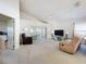 Bright living area with access to a screened lanai, featuring neutral colors and a ceiling fan at 3635 Kingswood Ct, Clermont, FL 34711