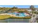 Community pool area surrounded by palm trees and manicured landscaping with a lake view at 3635 Kingswood Ct, Clermont, FL 34711