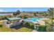 Inviting community pool area with lounge chairs, shaded tables, and serene waterfront views at 3635 Kingswood Ct, Clermont, FL 34711