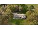 Aerial view shows single story home with large lawn and treed perimeter. Includes covered porch at 40610 Babb Rd, Umatilla, FL 32784