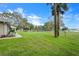 Lush green backyard with mature trees and access to a scenic lake view at 40610 Babb Rd, Umatilla, FL 32784