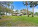 Expansive backyard with lush grass and mature trees, offering ample space and privacy at 40610 Babb Rd, Umatilla, FL 32784