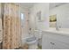 Cozy bathroom with a seashell-themed shower curtain and blue accents at 40610 Babb Rd, Umatilla, FL 32784