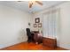 Bedroom has a desk, chair, and wood-look flooring illuminated by natural light at 40610 Babb Rd, Umatilla, FL 32784