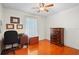 Bright bedroom features a desk, chair, and a chest of drawers on wood-look flooring at 40610 Babb Rd, Umatilla, FL 32784