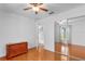 Bedroom with a wood-look floor, a ceiling fan and mirrored sliding doors at 40610 Babb Rd, Umatilla, FL 32784