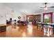 Dining area with gleaming hardwood floors, vaulted ceiling, and large windows with a view of the backyard at 40610 Babb Rd, Umatilla, FL 32784