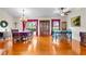 Open dining room featuring hardwood floors, a dining table with chairs, and views of the backyard at 40610 Babb Rd, Umatilla, FL 32784