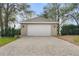 Detached two-car garage with a brick-paved driveway and manicured landscaping at 40610 Babb Rd, Umatilla, FL 32784