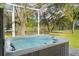 Enjoy outdoor relaxation in the hot tub surrounded by lush greenery and mature trees at 40610 Babb Rd, Umatilla, FL 32784