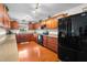 Bright kitchen with hardwood floors, wooden cabinets, modern appliances, and a view of the backyard at 40610 Babb Rd, Umatilla, FL 32784