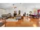 Bright living room with hardwood floors, fireplace, sofas, and dining area with a table and chairs at 40610 Babb Rd, Umatilla, FL 32784