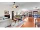 Bright and airy living room featuring hardwood floors, a fireplace, high ceilings, and views of the dining areas at 40610 Babb Rd, Umatilla, FL 32784