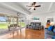 Relaxing living room with hardwood floors, a ceiling fan, comfortable seating, and a view of the lake at 40610 Babb Rd, Umatilla, FL 32784