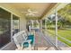 Relaxing screened porch features comfortable seating and serene views of the surrounding greenery at 40610 Babb Rd, Umatilla, FL 32784