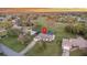 Aerial view of a house, showing the driveway, front lawn, screened-in pool, and surrounding trees at 425 N Pine Meadow Dr, Debary, FL 32713