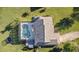 Aerial view of a house with a screened-in pool, patio, and a well-maintained lawn at 425 N Pine Meadow Dr, Debary, FL 32713