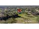 An aerial view of a house with a long driveway, a screened-in pool, and a large backyard at 425 N Pine Meadow Dr, Debary, FL 32713
