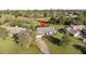 A marked aerial view of a house, showing the front lawn, long driveway, and a screened-in pool at 425 N Pine Meadow Dr, Debary, FL 32713