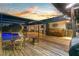 Spacious backyard with a screened-in pool area, wood pile and comfortable seating under a covered patio at 425 N Pine Meadow Dr, Debary, FL 32713